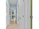 Well-lit hallway with access to multiple rooms and neutral decor at 9626 Channing Hill Dr, Ruskin, FL 33573