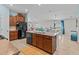 Modern kitchen with wooden cabinets, stainless steel appliances, and an island at 9626 Channing Hill Dr, Ruskin, FL 33573