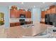 Kitchen with wooden cabinets, stainless steel appliances, and an island at 9626 Channing Hill Dr, Ruskin, FL 33573