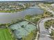 Aerial view of community tennis courts and a nearby basketball court at 9626 Channing Hill Dr, Sun City Center, FL 33573