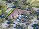 Aerial view of building with parking lot and surrounding landscape at 214 Woodlake Wynde # 14, Oldsmar, FL 34677