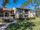 Two-story condo with well-manicured lawn and walkway at 214 Woodlake Wynde # 14, Oldsmar, FL 34677