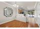 Bright dining area with hardwood floors, a stylish mirror, and adjacent kitchen access at 10334 Estero Bay Ln, Tampa, FL 33625
