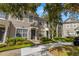Two-story townhome with gray exterior and landscaping at 10334 Estero Bay Ln, Tampa, FL 33625
