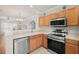 Modern kitchen with stainless steel appliances and wood cabinets at 10334 Estero Bay Ln, Tampa, FL 33625