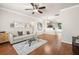 Spacious living room with hardwood floors, comfortable seating, and a view to the kitchen at 10334 Estero Bay Ln, Tampa, FL 33625