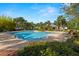 Community pool with lounge chairs and a shaded seating area at 10334 Estero Bay Ln, Tampa, FL 33625