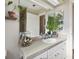 Bathroom with granite countertop, white cabinets, and a large mirror at 1121 Belladonna Dr, Brandon, FL 33510