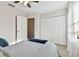 Bright bedroom with a striped bedspread and built-in closet at 1121 Belladonna Dr, Brandon, FL 33510