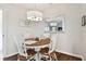 Bright dining area with wood table and four white chairs at 1121 Belladonna Dr, Brandon, FL 33510