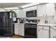 Kitchen with black appliances and white cabinets at 1121 Belladonna Dr, Brandon, FL 33510
