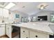 Modern kitchen features a breakfast bar, stainless steel appliances, and white cabinetry at 1121 Belladonna Dr, Brandon, FL 33510