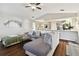 Open living room showcasing a gray sectional sofa and kitchen views at 1121 Belladonna Dr, Brandon, FL 33510