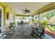 Relaxing screened porch with seating area, ceiling fan, and lush landscaping views at 1121 Belladonna Dr, Brandon, FL 33510