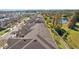 Aerial view of the community featuring townhomes, lush landscaping, and a serene lake in the background at 11546 Crowned Sparrow Ln, Tampa, FL 33626