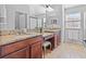 Bathroom featuring granite countertops, vanity and neutral tile floor at 11546 Crowned Sparrow Ln, Tampa, FL 33626