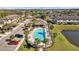 Aerial view of community pool with lounge chairs and surrounding landscape at 11546 Crowned Sparrow Ln, Tampa, FL 33626