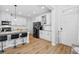 Modern kitchen featuring an island with bar seating, white cabinets, and stainless steel appliances at 11546 Crowned Sparrow Ln, Tampa, FL 33626