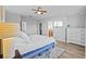 Bedroom featuring ceiling fan, TV, and white dresser next to the bed at 11546 Crowned Sparrow Ln, Tampa, FL 33626