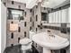 Elegant bathroom with dark tile, pedestal sink, and shower/tub combo at 1201 Kapok Cir, Clearwater, FL 33759