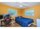 Bright bedroom with a full bed, desk setup, and large windows at 1201 Kapok Cir, Clearwater, FL 33759