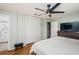 Bright bedroom with a large bed, ceiling fan, and mirrored closet doors at 1201 Kapok Cir, Clearwater, FL 33759