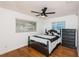 Charming bedroom with a full bed, ceiling fan, and hardwood floors at 1201 Kapok Cir, Clearwater, FL 33759