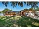 Ranch style home with two car garage and lush lawn at 1201 Kapok Cir, Clearwater, FL 33759