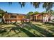 Brick ranch home with a large yard and mature trees at 1201 Kapok Cir, Clearwater, FL 33759