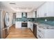 Modern kitchen with stainless steel appliances and granite counters at 1201 Kapok Cir, Clearwater, FL 33759