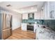 Updated kitchen with stainless steel appliances and light wood flooring at 1201 Kapok Cir, Clearwater, FL 33759