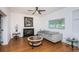 Cozy living room featuring a fireplace, neutral colored couch, and hardwood floors at 1201 Kapok Cir, Clearwater, FL 33759