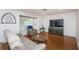 Living room featuring hardwood floors and large windows at 1201 Kapok Cir, Clearwater, FL 33759