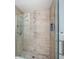Large walk-in shower with neutral tile and glass enclosure at 1201 Kapok Cir, Clearwater, FL 33759