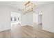 Bright dining room features hardwood floors and a gold chandelier at 12563 Gulliver Rd, Spring Hill, FL 34609