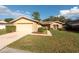 Front view of a single-Gathering home with a well-maintained lawn at 14811 Oak Vine Dr, Lutz, FL 33559