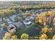 Aerial view of a community with homes near a pond, nestled among trees at 18127 Sandy Pointe Dr, Tampa, FL 33647