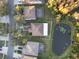 Aerial view showcasing a home with a fenced yard, adjacent to a scenic pond at 18127 Sandy Pointe Dr, Tampa, FL 33647