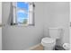 Powder room offers a toilet and window at 18127 Sandy Pointe Dr, Tampa, FL 33647