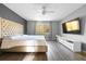 Spacious bedroom featuring a large window, wood-look floors, and modern decor at 18127 Sandy Pointe Dr, Tampa, FL 33647
