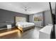 Bedroom featuring a large window, wood-look floors, and modern decor at 18127 Sandy Pointe Dr, Tampa, FL 33647