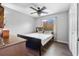 Bedroom features a ceiling fan, window, and wood-look flooring at 18127 Sandy Pointe Dr, Tampa, FL 33647