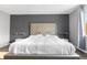 Bedroom features a large plush bed, wood-look floors, and modern decor at 18127 Sandy Pointe Dr, Tampa, FL 33647