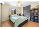 Cozy bedroom with natural light, featuring a large bed, dark accent wall, and ample storage at 18127 Sandy Pointe Dr, Tampa, FL 33647