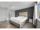 Bedroom featuring a large bed, wood-look floors, and modern decor at 18127 Sandy Pointe Dr, Tampa, FL 33647