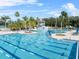 Stunning community pool with a slide, lap lanes, sun loungers, and lush landscaping perfect for relaxation and recreation at 18127 Sandy Pointe Dr, Tampa, FL 33647