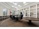 Spacious conference room with large table, comfortable seating, bookshelves, and American flag at 18127 Sandy Pointe Dr, Tampa, FL 33647