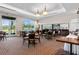 Well-lit dining room with large windows, a bar, and multiple tables and chairs with a carpeted floor at 18127 Sandy Pointe Dr, Tampa, FL 33647