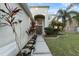 Front entrance with a walkway, landscaping, and palm trees at 18127 Sandy Pointe Dr, Tampa, FL 33647