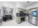 Stylish eat-in kitchen features stainless steel appliances and granite countertops, adjacent to a dining area at 18127 Sandy Pointe Dr, Tampa, FL 33647